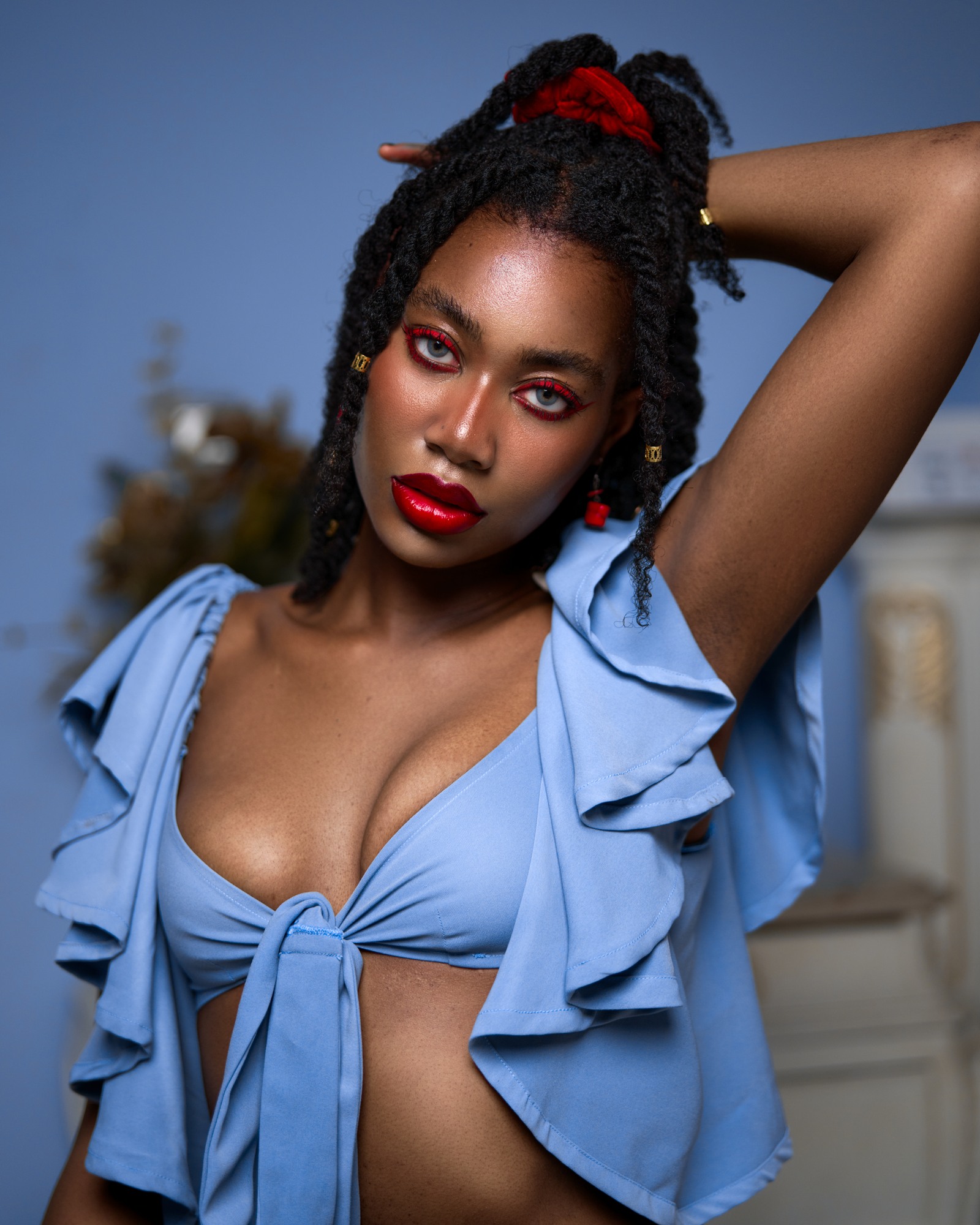 EfikZara with natural twists gathered up, wearing a blue ruffled top