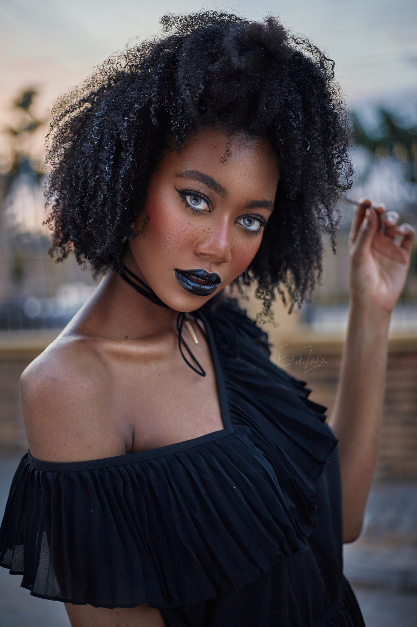 EfikZara wearing her natural coils and a black off-the-shoulder outfit