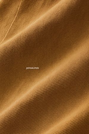 Smooth golden cotton fabric with diagonal texture