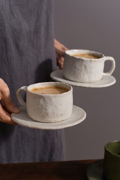 Video of person placing ceramic coffee cup on table