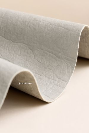Curved natural fiber fabric close-up on neutral background