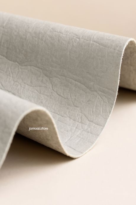 Curved natural fiber fabric close-up on neutral background