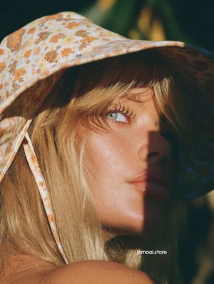 Portrait of a Freckled Woman in Sun Hat with Golden Light and Shadows