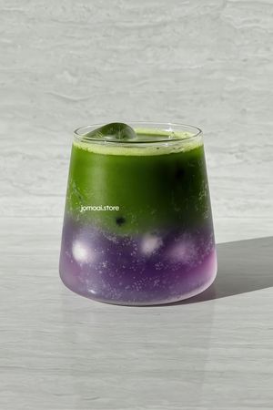 Layered matcha and butterfly pea iced drink in glass