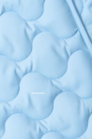 Soft light blue quilted fabric with wave stitch texture