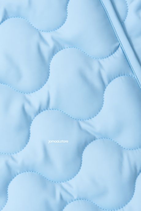 Soft light blue quilted fabric with wave stitch texture