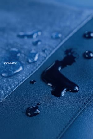 Water droplets on blue waterproof textile surface
