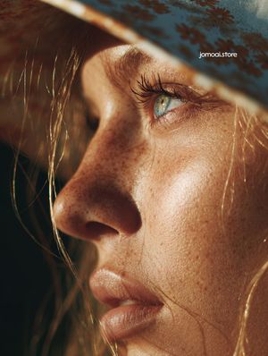 Extreme Close-Up Portrait of Woman with Freckles and Sun Hat