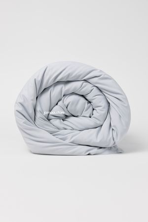Rolled light grey comforter with soft microfiber texture