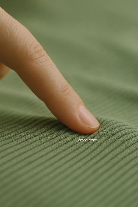 Finger Touching Soft Ribbed Fabric – Sensory Close-Up in Green Tones