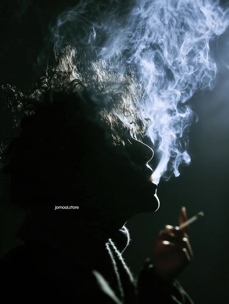 Moody Portrait of Smoking Man with Dramatic Smoke and Light