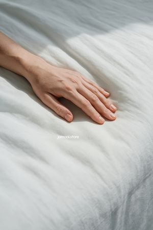 Delicate Female Hand on White Linen – Soft Minimalist Light Aesthetic