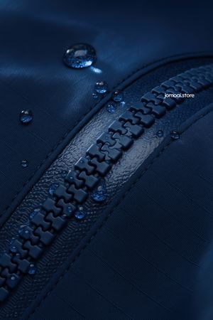 Waterproof plastic zipper on technical fabric with droplets