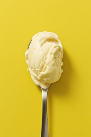 Vanilla Ice Cream Scoop on Spoon with Bold Yellow Backdrop