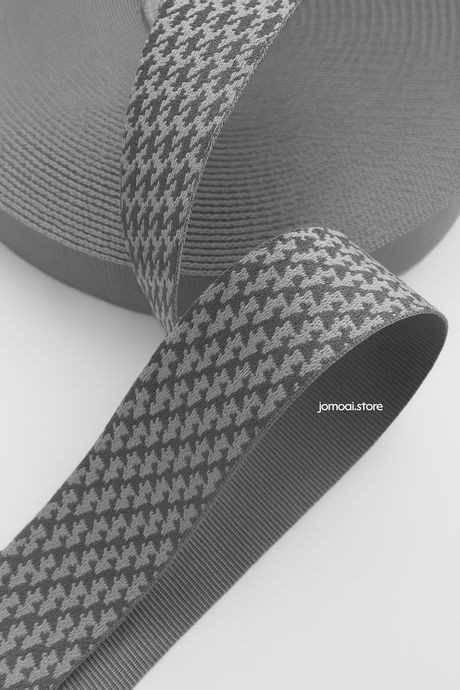 Black and gray houndstooth patterned ribbon close-up