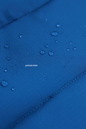 Water droplets on technical blue ripstop fabric