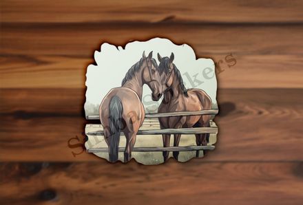 Two brown horses separated by fence