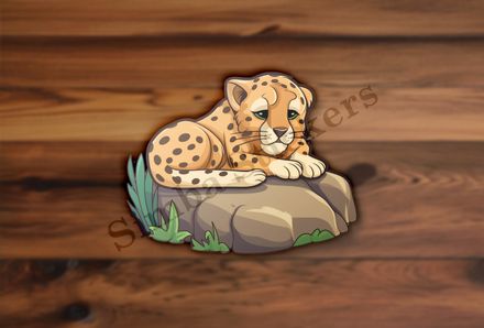 Baby cheetah on a leafy rock