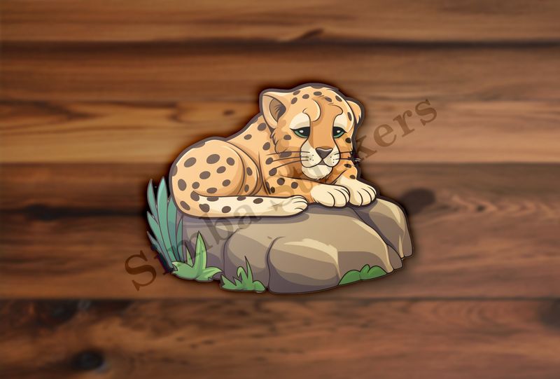 Baby cheetah on a leafy rock