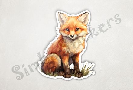 Baby red fox sitting up looking innocent