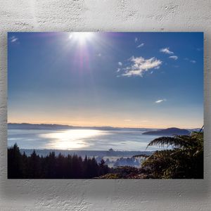 Scenic Sunrise Over Lake Rotorua with Forest and Sun Rays Photo Download