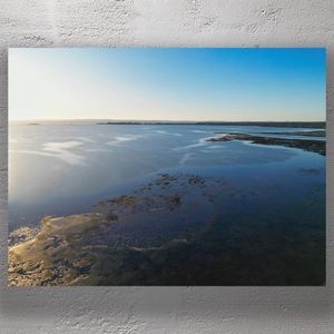 Serene Coastal Landscape at Sunrise Aerial Ocean View with Reflective Waters Photo Download
