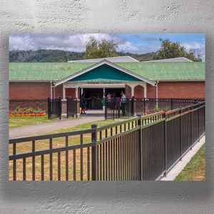 Trentham Racecourse Stables Historic Brick Building with Green Roof and Black Fencing Photo Download