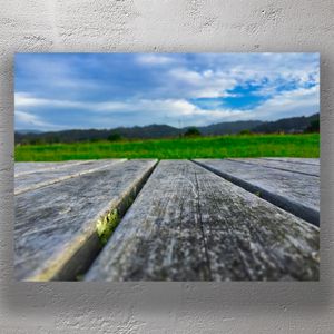 Rustic Wooden Picnic Table with Scenic Green Landscape Photo Download