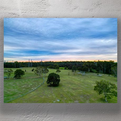 Recreational Reserve at Sunset  Lush Green Landscape and Dramatic Sky Photo Download