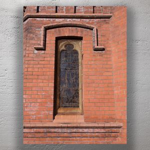 Stained Glass Church Window with Protective Mesh Historic Red Brick Architecture Photo Download