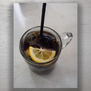 Refreshing Iced Cola with Lemon Slice in Glass Mug Summer Drink Close-Up Photo Download