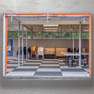 Outdoor Café Seating Area with Stacked Chairs and Tables Photo Download