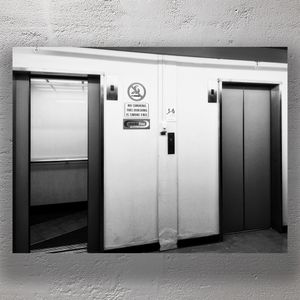 Black and White Elevator Doors in Urban Building Hallway Photo Download