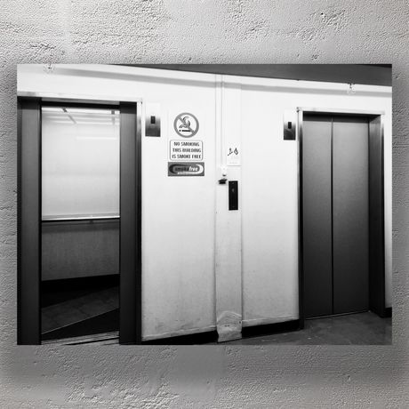 Black and White Elevator Doors in Urban Building Hallway Photo Download