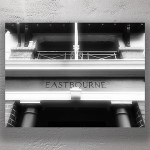 Historic Building Entrance with Eastbourne Signage Black and White Architectural Photo Download