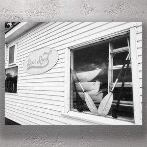 Vintage Boat Shed Exterior with Canoes and Paddles Photo Download