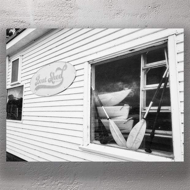 Vintage Boat Shed Exterior with Canoes and Paddles Photo Download
