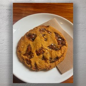 Gourmet Salted Caramel Cookie on White Plate Irresistible Sweet and Salty Treat Photo Download