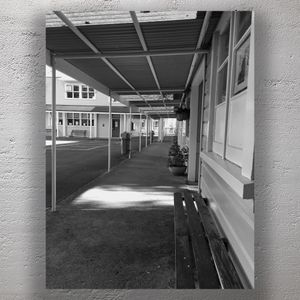 School Courtyard with Covered Walkway Vintage Architecture and Empty Benches Photo Download