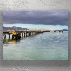 Industrial Pier Over Calm Waters Dramatic Sky and Coastal Landscape Photo Download