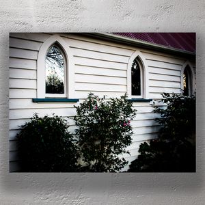 Gothic Arch Windows on White Weatherboard Church Wall with Garden Shrubs Photo Download