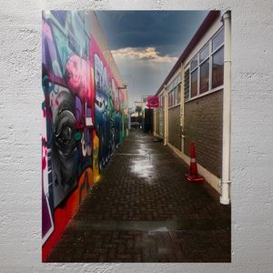 Colorful Urban Alleyway with Graffiti Art and Moody Sky in Napier New Zealand Photo Download