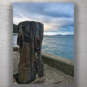 Weathered Wharf Post by the Sea Rustic Coastal Scene with Ocean View Photo Download