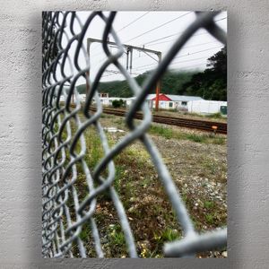 Through the Fence Railway Tracks and Industrial Landscape Photo Download