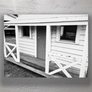 Rustic Tiny House with Weathered Porch Vintage Charm in Black and White Photo Download