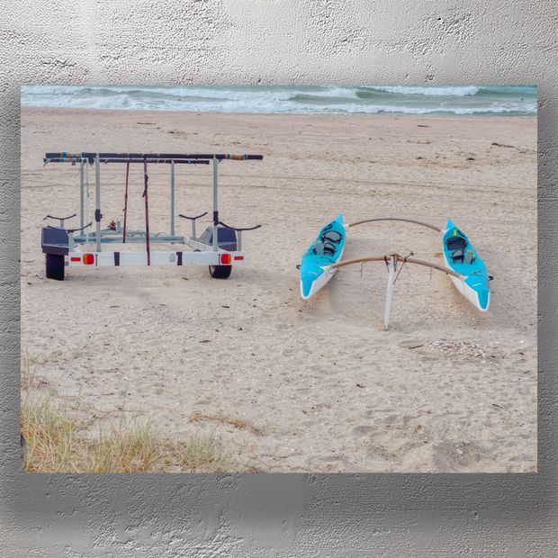 Twin Outrigger Canoes on Sandy Beach with Trailer by the Ocean Photo Download