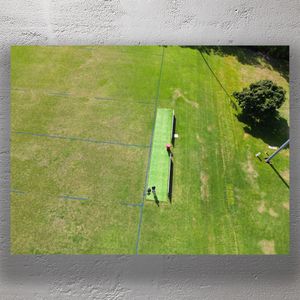 Aerial View of Cricket Pitch on Lush Green Sports Field Drone Photography Photo Download