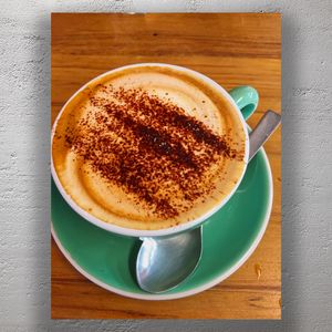 Cappuccino with Cocoa Topping in Green Cup Cozy Coffee Shop Vibes Photo Download
