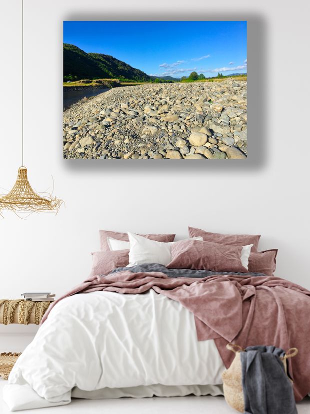 Rocky Riverbank Landscape Tranquil Nature View with Blue Sky and Green Hills Photo Download