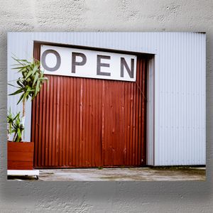 Industrial Warehouse Entrance with Open Sign and Potted Plant Photo Download